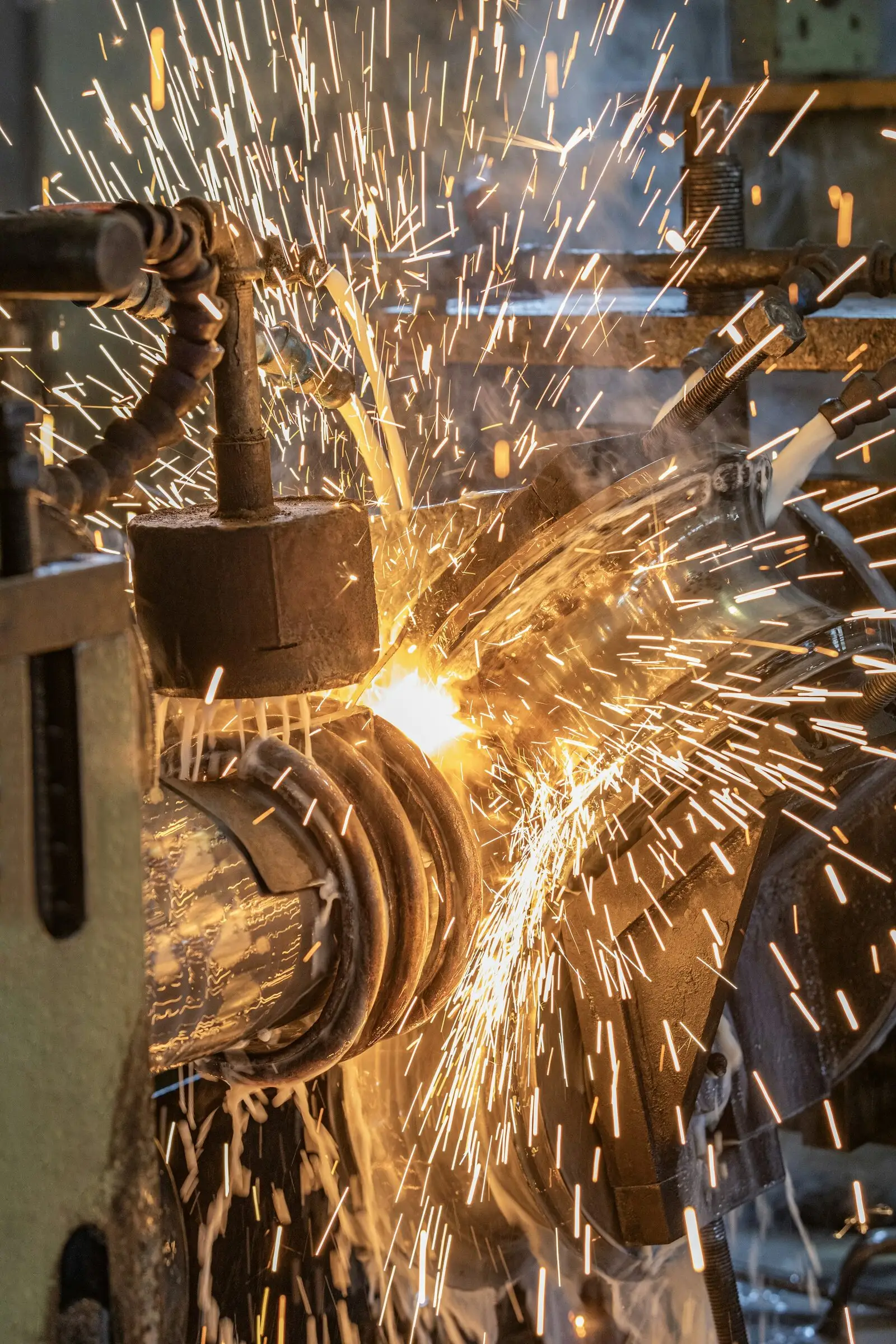 Sparks bursting from the weld point of a tube mill as the pipe passes between the squeeze rolls.